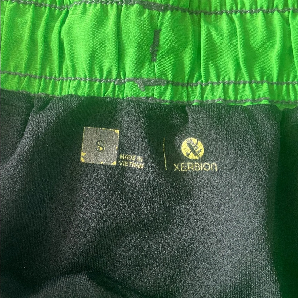 $2 - Xersion Charcoal Shorts with Neon Green Trim - Picture 2 of 7